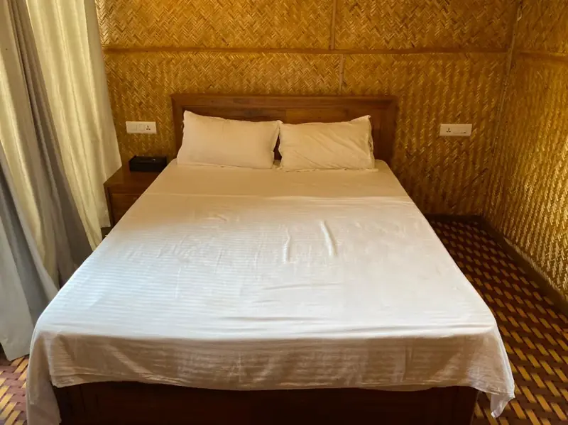 Bedroom inside the Bamboo Hut with woven bamboo walls
