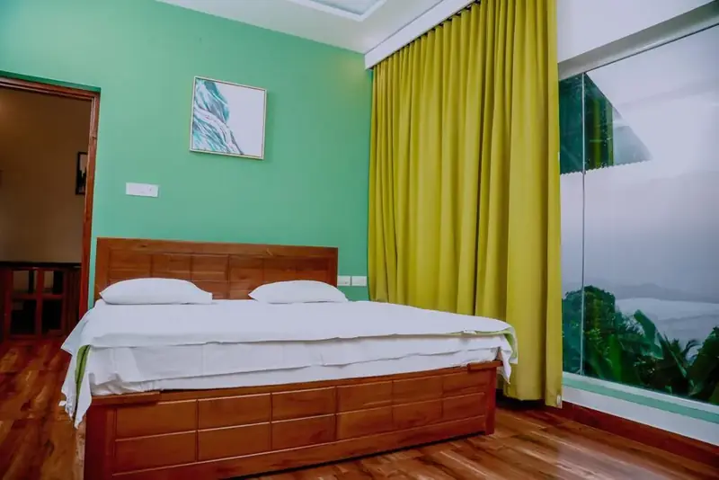 Double bed beside glass walls in La Vista Villa