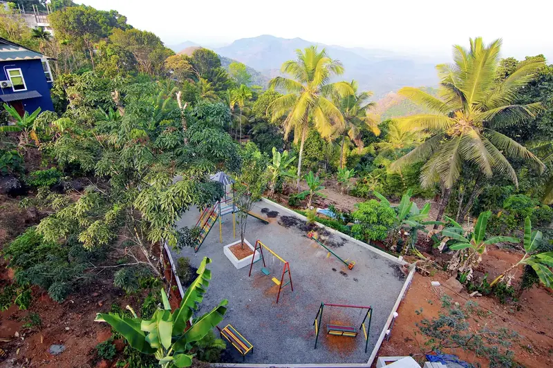 Aerial view of Purayil Resort gardens with the Western Ghats mountains behind