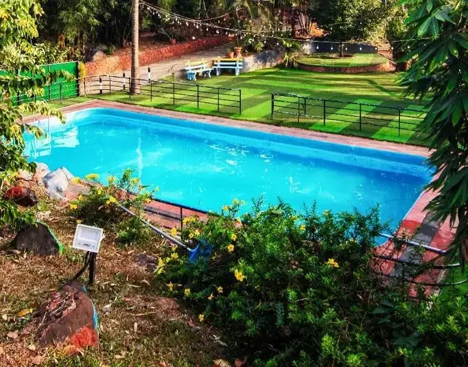 Swimming pool set in the gardens of Purayil Resort